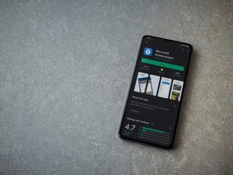 Microsoft Authenticator app play store page on the display of a black mobile  Stock Photos