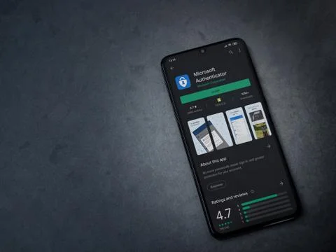 Microsoft Authenticator app play store page on the display of a black mobile  Stock Photos