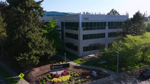 Microsoft campus office building with glass facade, colorful flower beds Video stock 336503956