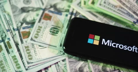 Microsoft Logo on iphone surrounded by $100 Bills. Microsoft Profits Layout. Stock Footage 169008652