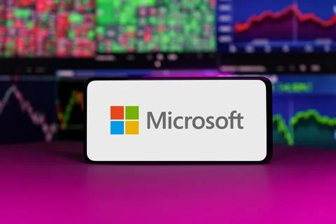 Microsoft logo on mobile phone screen company shares rise or fall on stock Stock Photos