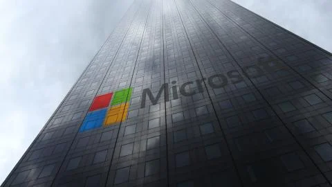 Microsoft logo on a skyscraper facade reflecting clouds. Editorial 3D rendering Illustrazione stock
