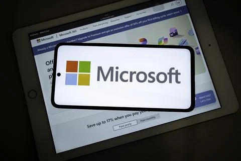 Microsoft logo on smartphone with tablet Fotos de archivo