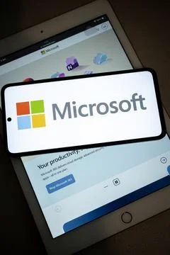Microsoft logo on smartphone with tablet Fotos de archivo