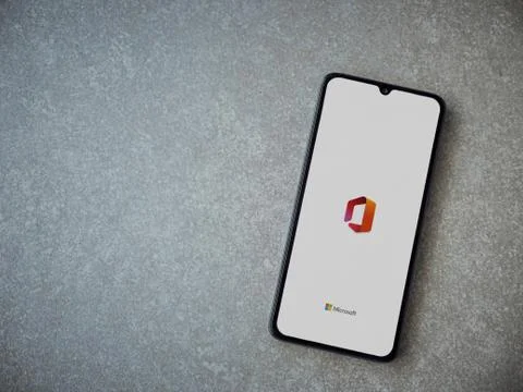 Microsoft Office app launch screen with logo on the display of a black mobile Stock Photos