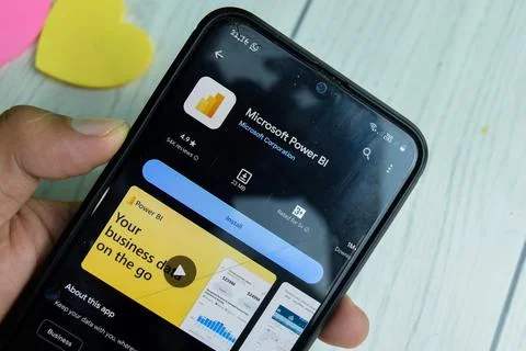 Microsoft Power BI application on Smartphone screen. Photos