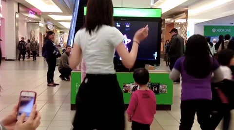 Microsoft staff demonstrates with children dance game 스톡 동영상 52116864