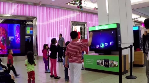 Microsoft staff demonstrates with children dance game Video stock 54299839