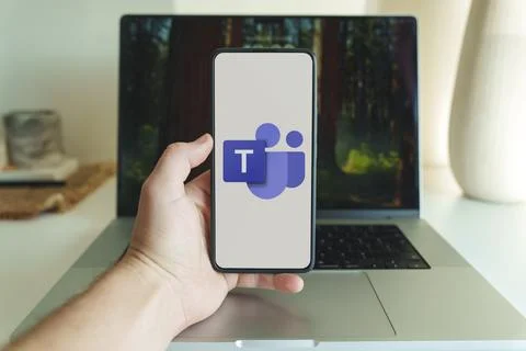 Microsoft teams application logo in front of laptop Stock Photos