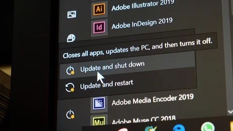 Microsoft windows Start key and selecting Update and Shut down computer Stock Footage 119021899