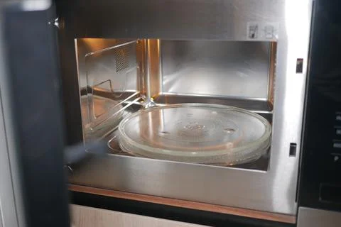 Microwave with glass turntable inside kitchen cabinet Stock Photos