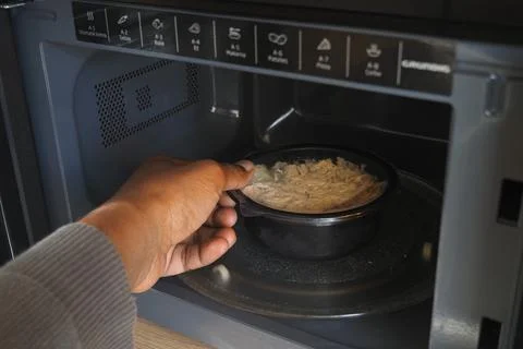 Microwave meal being heated inside a modern microwave oven Stock Photos