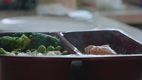 Microwave meal being prepared for serving Stock Footage 210774479