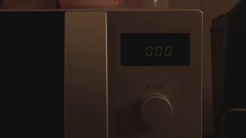 Microwave oven clock marks midnight Stock Footage 74806764