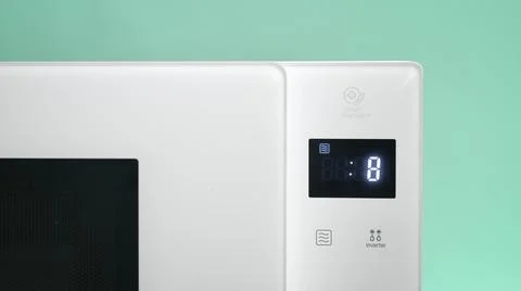 Microwave timer counting down from ten on blue background . Digital clock . Stock Photos