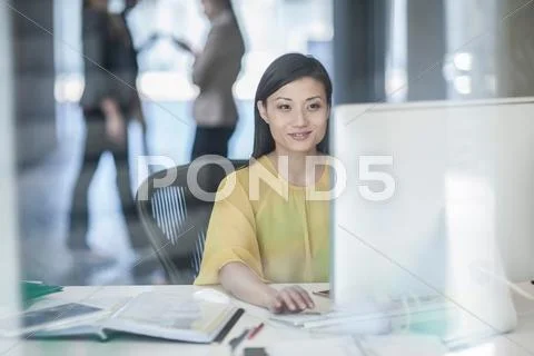 Mid Adult Businesswoman Using Computer