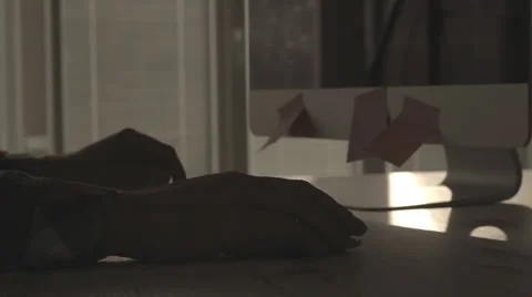Mid adult man using computer mouse and typing on keyboard Stock Footage 63616087