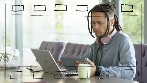 Mid-adult man using tablet and shifting to laptop tapping causing sketch frames Stock Footage 330620189