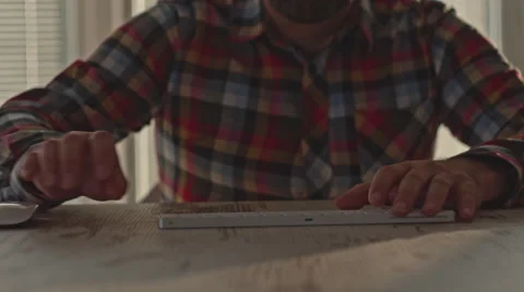 Mid adult man working on computer Stock Footage 63654428