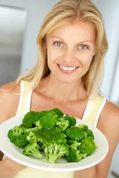 Mid Adult Woman Holding A Plate Of Broccoli Stock Photos