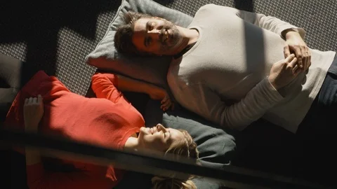 Mid-age Couple lying on Floor and talking Stock Footage 88124889