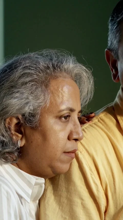 Mid age Indian couple spending peaceful time together at home Stockbeeldmateriaal 343361023