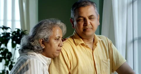 Mid age Indian couple spending peaceful time together at home Video stock 343363471