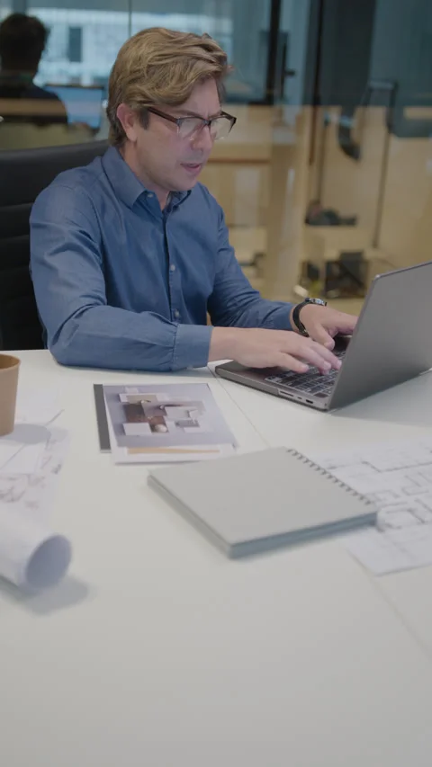 Mid-Aged Architect Typing on Laptop at Work in the Office Stock Footage 249571963