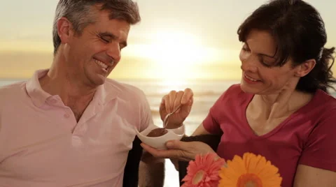 Mid aged couple in beach cafe Stock Footage 43676615