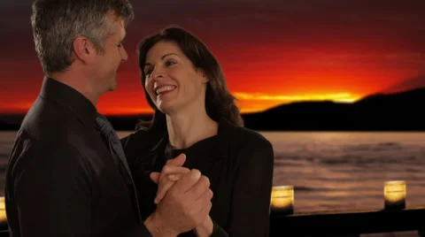 Mid aged couple dancing in sunset Stock Footage 43676637