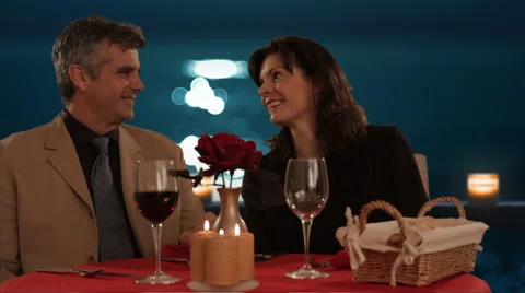 Mid aged couple dining in moonlight Stock Footage 43676798
