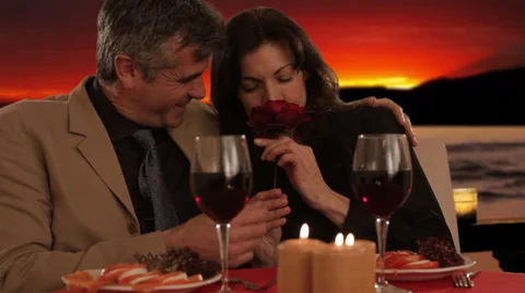 Mid aged couple dining in sunset Stock Footage 43676688