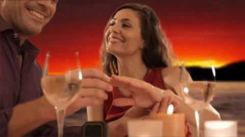 Mid aged couple at dinner giving ring Stock Footage 43676055