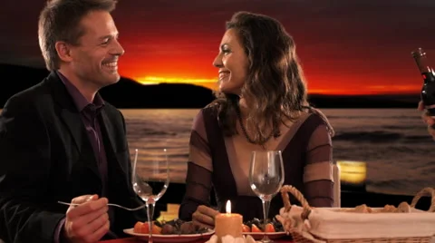 Mid aged couple at dinner waiter pouring wine Stock Footage 43675928