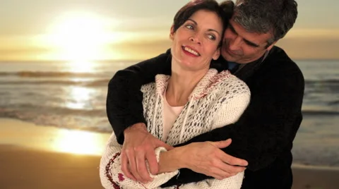 Mid aged couple in sunset Stock Footage 43676484