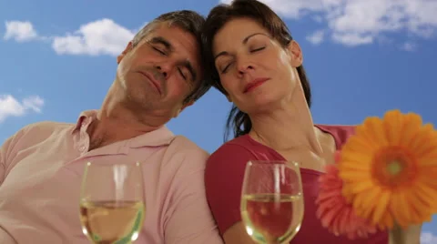 Mid aged couple with wine glasses Video stock 43676600