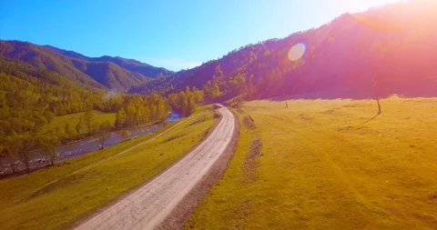 Mid air flight over fresh mountain river and meadow at sunny summer morning Stock Footage 89406884