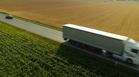 Mid air passing local road traffic between fields 動画素材 44972999