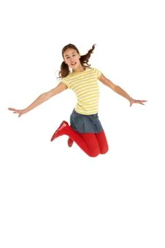 Mid Air Studio Shot Of Young Girl Jumping In Air Stock Photos