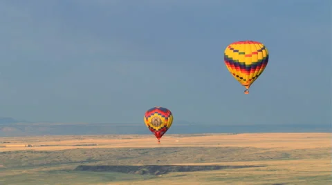 Mid-air view of two hot air balloons gliding over Albuquerque. Shot in 2008. Stock Footage 59538895