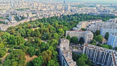 Mid angle drone view of the Parc des buttes chaumont in Paris cityscape at Stock-Footage 341075070