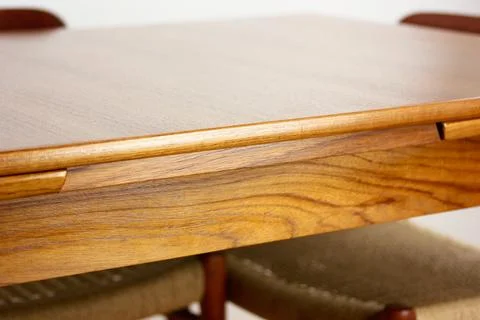 A mid century teak dining table with four chairs from the 50s 60s Danish De.. Stock Photos