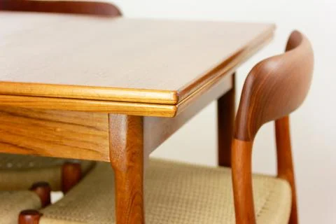 A mid century teak dining table with four chairs from the 50s 60s Danish De.. Stock Photos