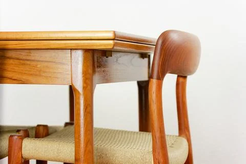 A mid century teak dining table with four chairs from the 50s 60s Danish De.. Stock Photos