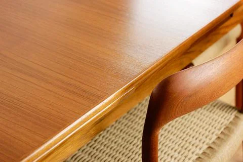 A mid century teak dining table with four chairs from the 50s 60s Danish De.. Stock Photos