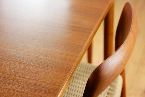A mid century teak dining table with four chairs from the 50s 60s Danish De.. Stock Photos