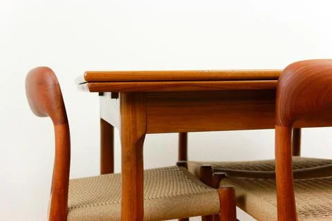 A mid century teak dining table with four chairs from the 50s 60s Danish De.. Stock Photos