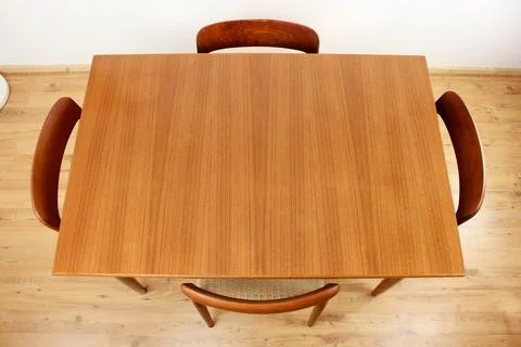 A mid century teak dining table with four chairs from the 50s 60s Danish De.. Stock Photos