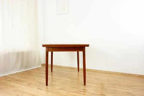 A mid century teak dining table with four chairs from the 50s 60s Danish De.. Stock Photos