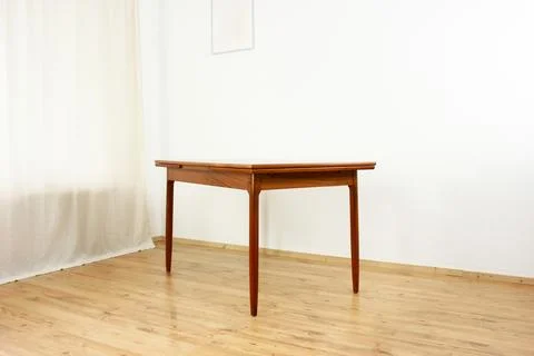 A mid century teak dining table with four chairs from the 50s 60s Danish De.. Stock Photos